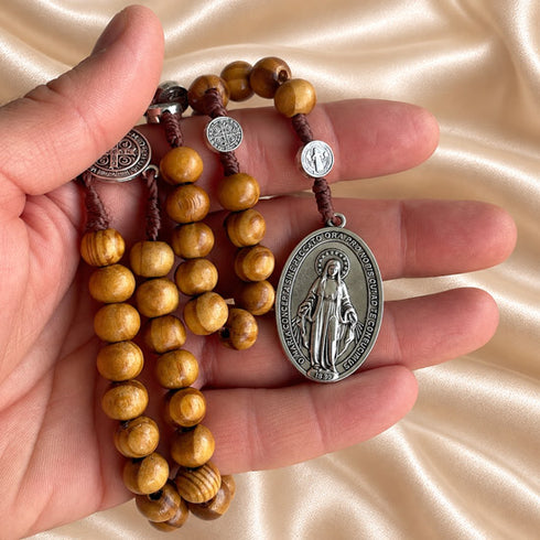 Saint Benedict and Miraculous Medal olive wood rosary arranged to show beads and crucifix