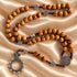 Detailed Saint Benedict olive wood rosary arranged to show beads and Crown of Thorns crucifix