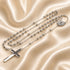 St. Benedict stainless steel rosary necklace with long ball-chain strands and cross centerpiece