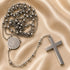 St. Benedict stainless steel rosary necklace featuring round medal charm and long cross pendant