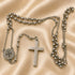 St. Benedict stainless steel rosary necklace showing round medal charm and cross pendant