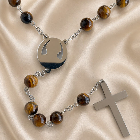 A rosary with polished brown tiger's eye beads, a round silver pendant with, and a flat silver cross.