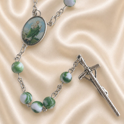Rosary with green and white marbled beads, a silver-tone chain, an oval medallion, and a silver crucifix.