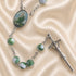 Rosary with green and white marbled beads, a silver-tone chain, an oval medallion, and a silver crucifix.