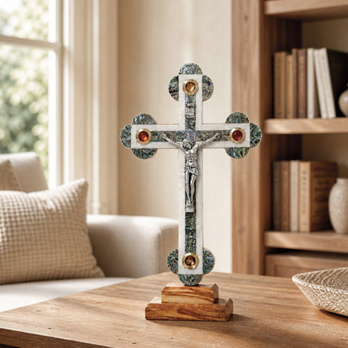 Budded decorative cross on a table in a sunny living room