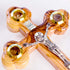 A pack shot of a detail on hand-crafted standing olive wood crucifix with halo and intricate details, featuring olive leaves, dried flowers, holy soil and incense, against a white background.