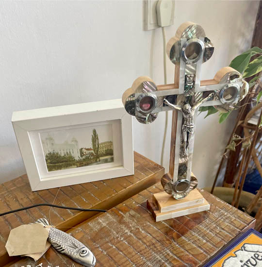 Large olive wood budded cross with nacre, crucifix and Four Holy Elements standing on a table.