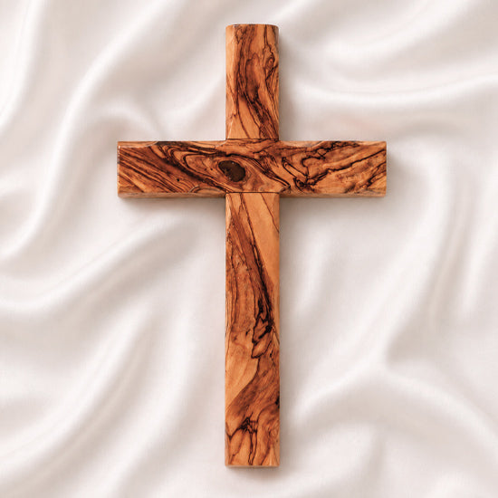 Handmade olive wood Thorn cross from Bethlehem on white surface