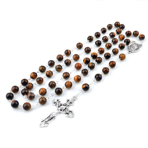 Brown rosary with silver crucifix on a white background