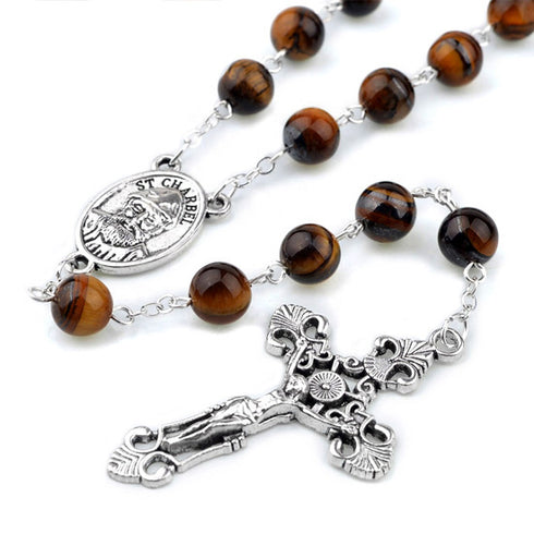 St.Charbel Rosary with brown beads and silver cross on a white background