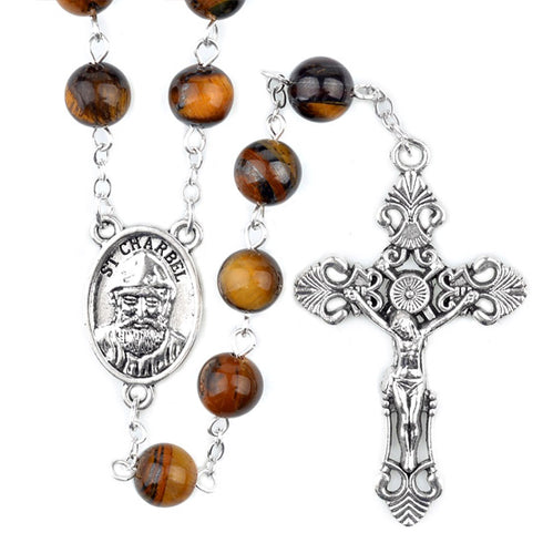 St.Charbel Rosary with brown beads and silver cross on a white background