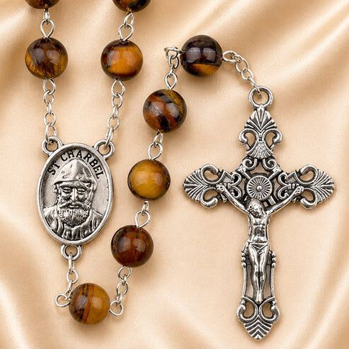 A St. Charbel rosary featuring polished brown tiger's eye beads, a silver St.