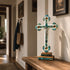 Decorative cross with turquoise and gold accents on a wooden surface in a home setting.