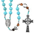 Turquoise beaded rosary with wooden beads and silver cross on a white background