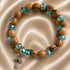 Olive wood wrap bracelet with turquoise crystal accents and dangling cross charm
