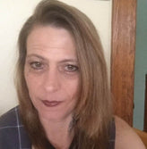 A long haired brunette middle age woman.