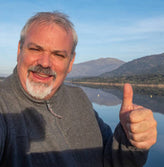 Older man giving thumb up in the nature