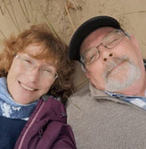 Elderly couple smiling at the camera