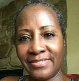 Face of an older African woman on green background