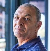 Dark skin older man in blue shirt