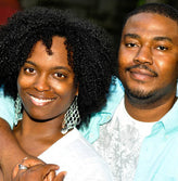 Happy and smiling young African couple holding hands.
