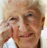 Smiling caucasian older lady with white hair.