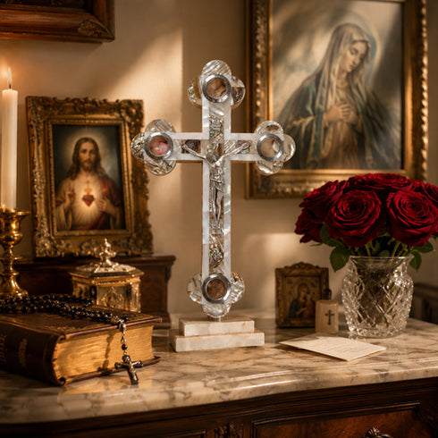 Budded white standing crucifix on home altar with bible, roses and paintings