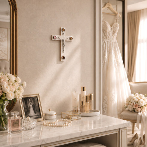 Wedding dress hanging in a room with a marble table, flowers, and decor.