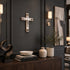 Decorative elements including a cross, sculpture, books, and plants in a room setting.