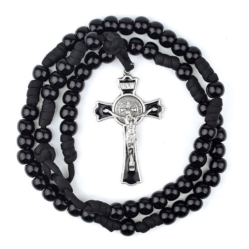 Black beaded rosary with a silver Saint Benedict cross on a white background
