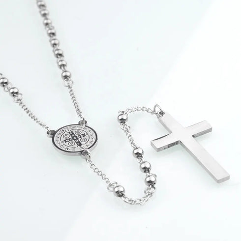 Stainless steel 4mm bead rosary with Saint Benedict centrepiece and a cross, set against clean white.