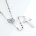 Stainless steel 4mm bead rosary with Saint Benedict centrepiece and a cross, set against clean white.