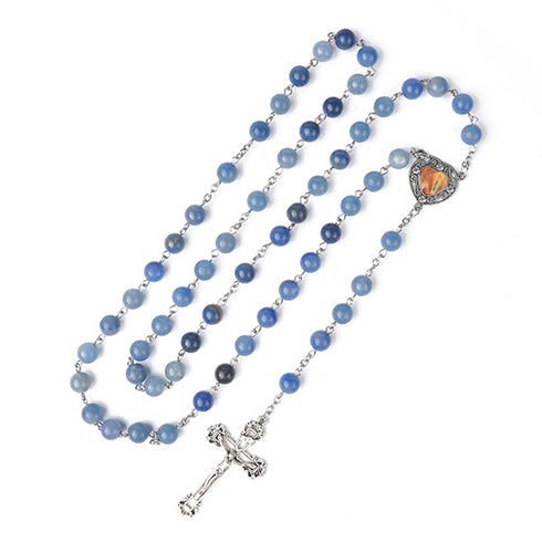 Blue stone rosary with a heart-shaped center piece and crucifix on a white background