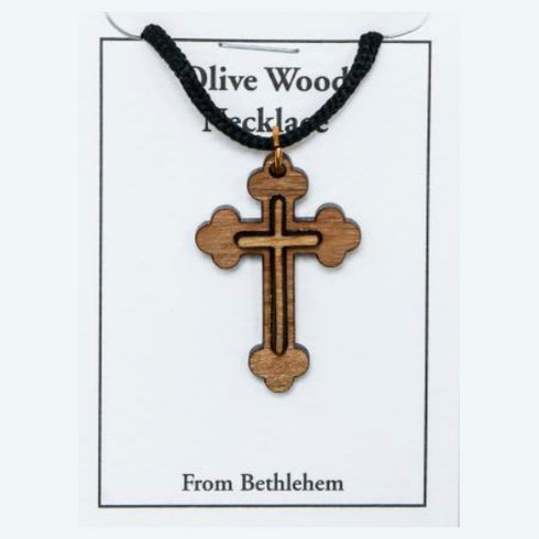 Wooden cross necklace on a card with 'Olive Wood Necklace From Bethlehem' text.