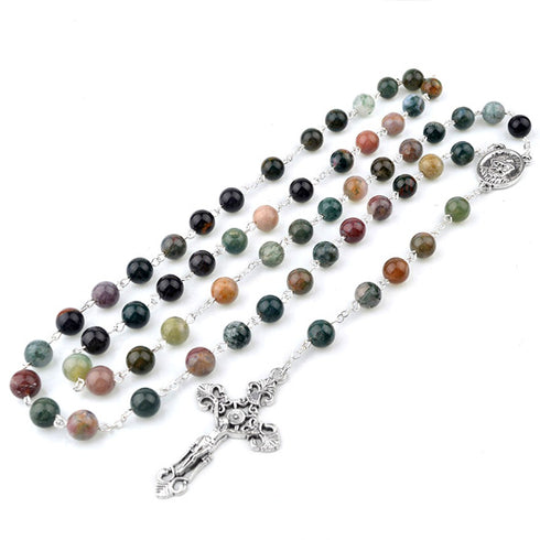 Multicolored beaded rosary with a silver cross on a white background