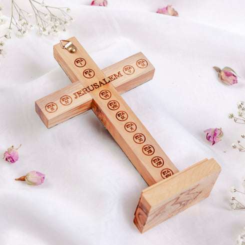 Back of standing latin cross with "Jerusalem" and Stations of Cross engraved, on white background.