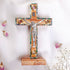 Small latin standing cross with crucifix, mother of pearl inlay and Four Elements, against white background.