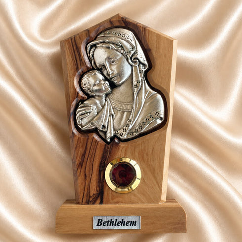 Madonna and Child olive wood plaque with natural grain and bark edge, shown upright on a neutral background
