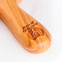 Olive wood comfort cross with the Piece of Holy Land logo, shown on white background with roses