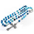 Blue beaded rosary with a silver cross on a white background