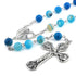 Blue rosary with silver cross and heart charm on a white background