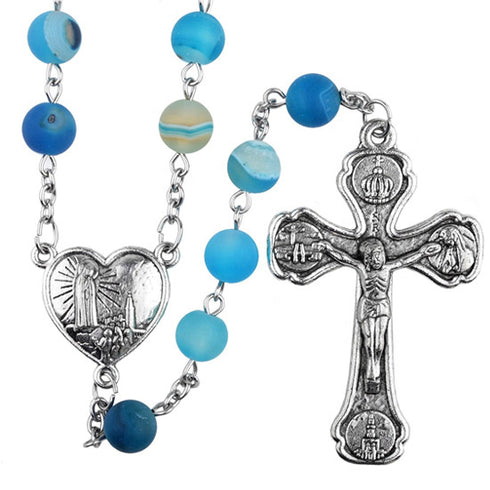Blue rosary with silver heart centrepiece  and cross on a white background