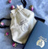Piece of Holy Land cotton branded bag and box on blue background
