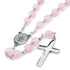 Pink St.Benedict rosary with a silver cross on a white background
