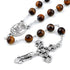 St.Charbel Rosary with brown beads and silver cross on a white background