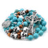 Turquoise beaded rosary with a celtic cross on a white background