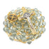 White glass beads rosary with gold chain and crucifix on a white background.