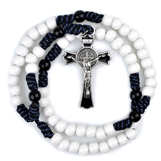 White beaded rosary with blue and black accents and a silver cross on a white background