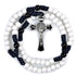 White beaded rosary with blue and black accents and a silver cross on a white background