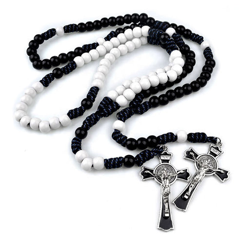 Black and white beaded rosary with silver cross on a white background